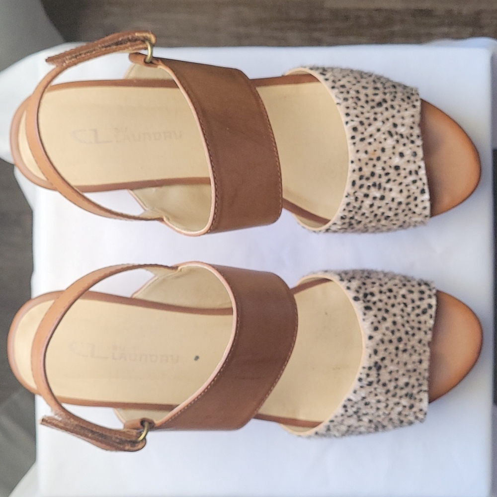 Brown wedges with a detail strap on the front. Size 8 true to size.